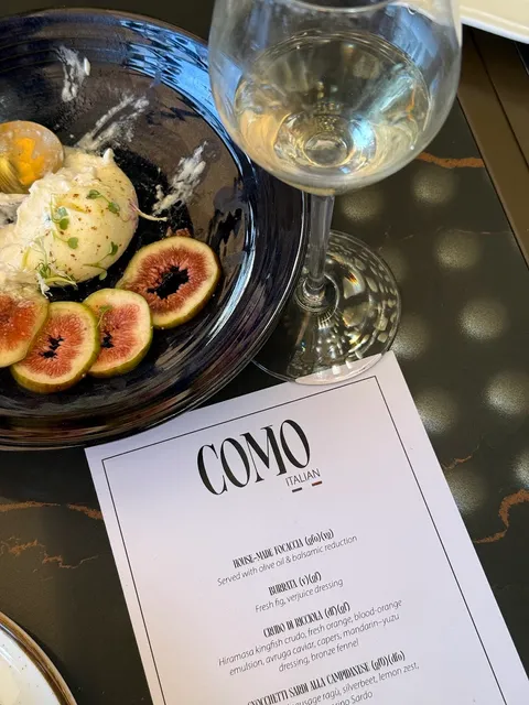 Como printed menu beside wine and burrata
